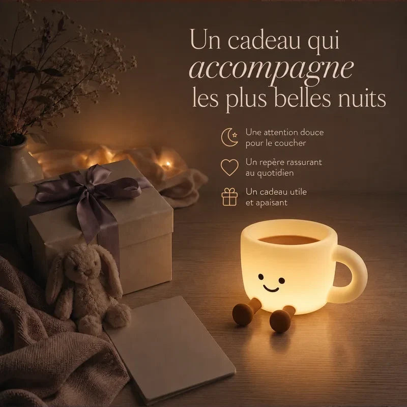 Veilleuse en forme de tasse à café souriante présentée dans une ambiance cadeau avec une boîte et un ruban.