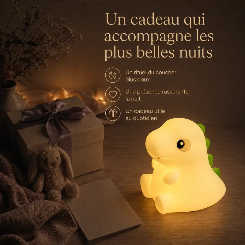 Veilleuse dinosaure tactile rechargeable, de couleur jaune, présentée dans une ambiance cadeau avec une boîte et un ruban.