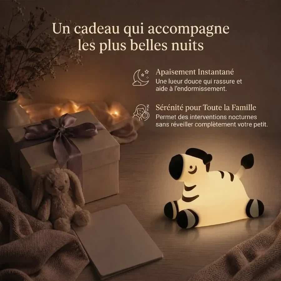 Veilleuse en forme de zèbre présentée dans une ambiance cadeau avec une boîte et un ruban.