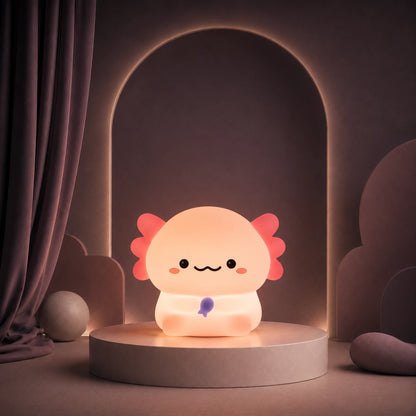 Veilleuse en forme d’axolotl debout allumée sur un podium mauve.