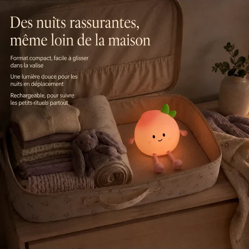 Veilleuse en forme de pêche souriante rangée dans une valise pour accompagner un enfant en voyage.