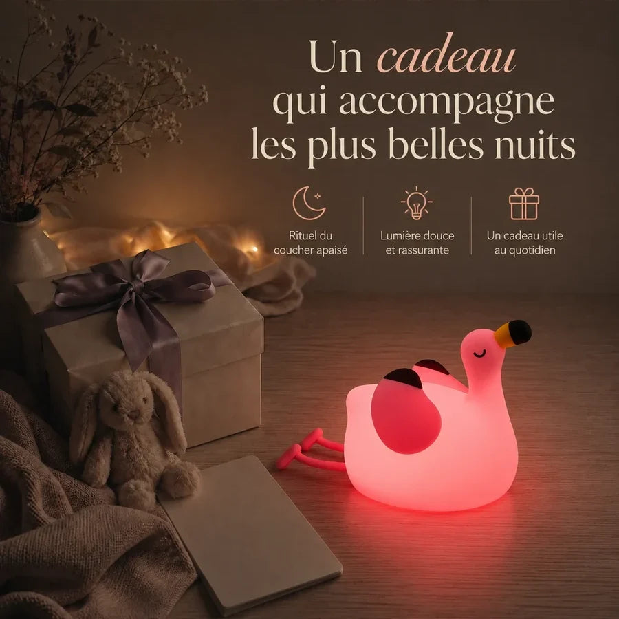 Veilleuse en forme de flamant rose présentée dans une ambiance cadeau avec une boîte et un ruban.