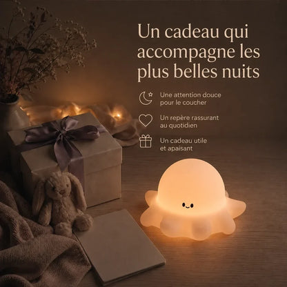 Veilleuse en forme de poulpe présentée dans une ambiance cadeau avec une boîte et un ruban.